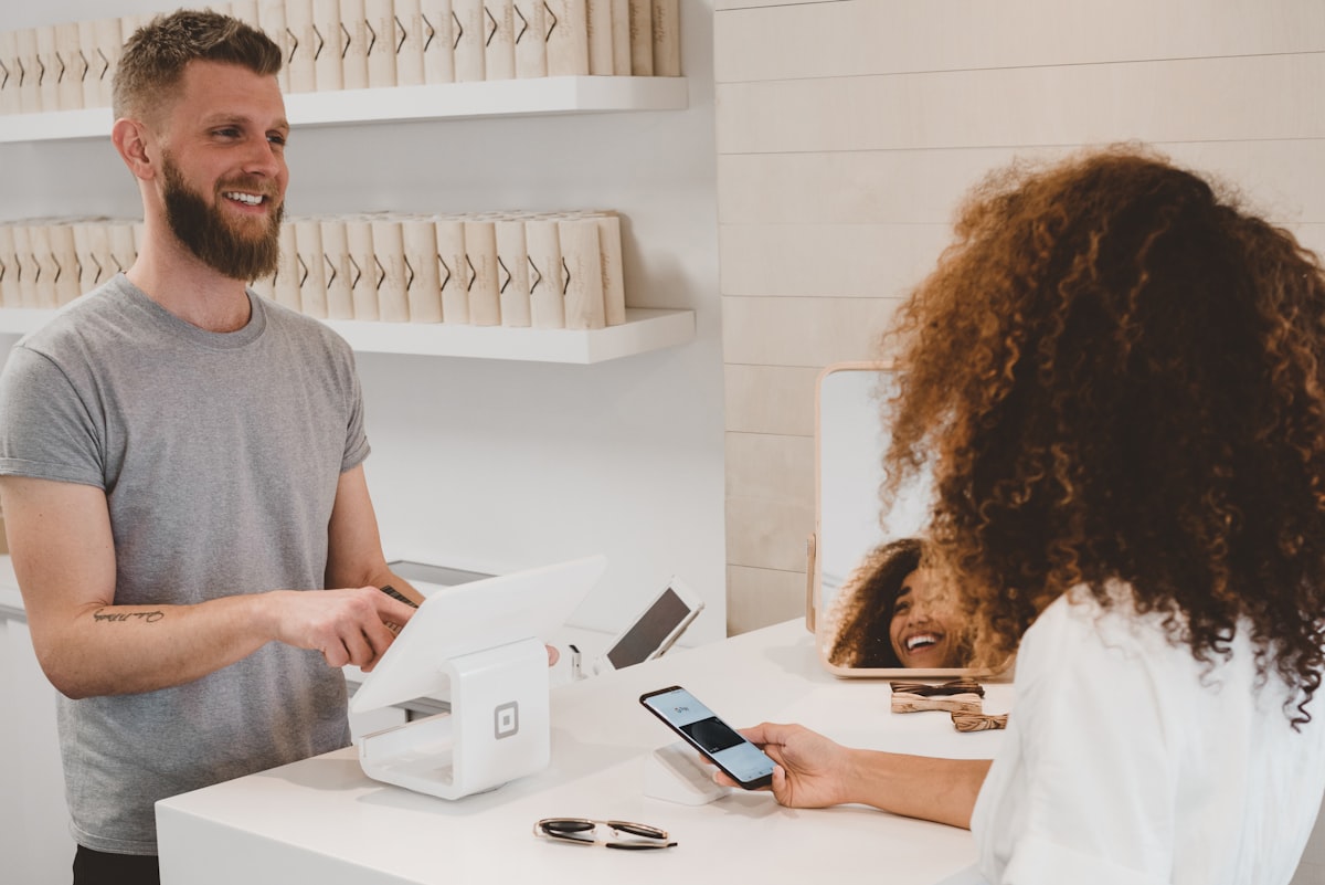 Customer paying at a retail counter with a card terminal